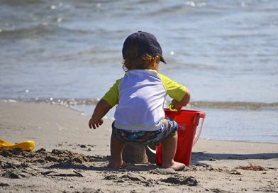 Kid on the beach building a sand castle